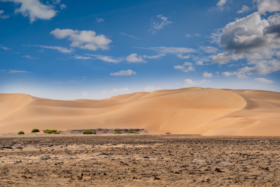 sand dunes in the desert with blue coudy sky from LIWA desert Abu Dhabi