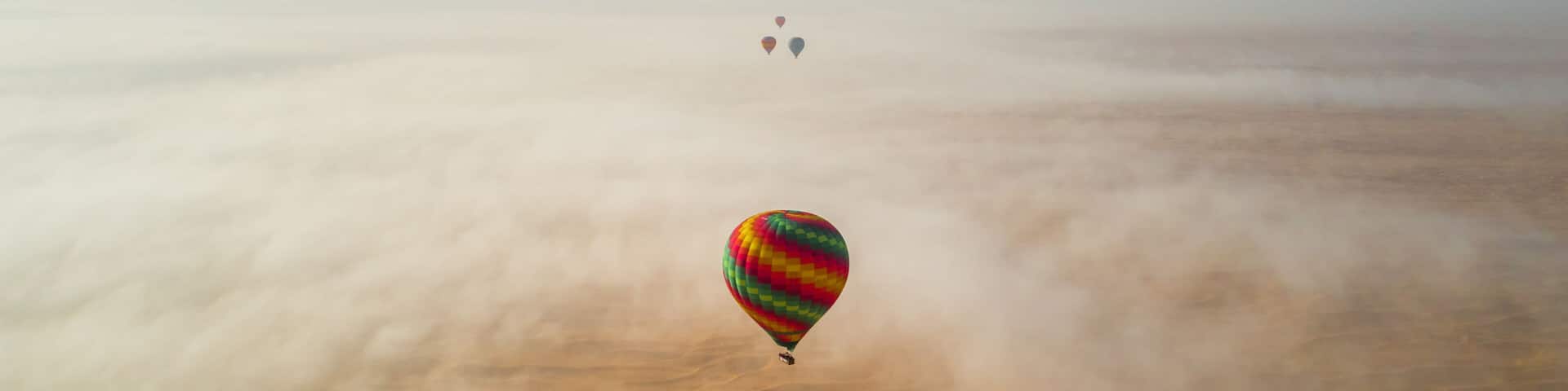 Aerial view of group of hot air balloon flying over Murqquab desert