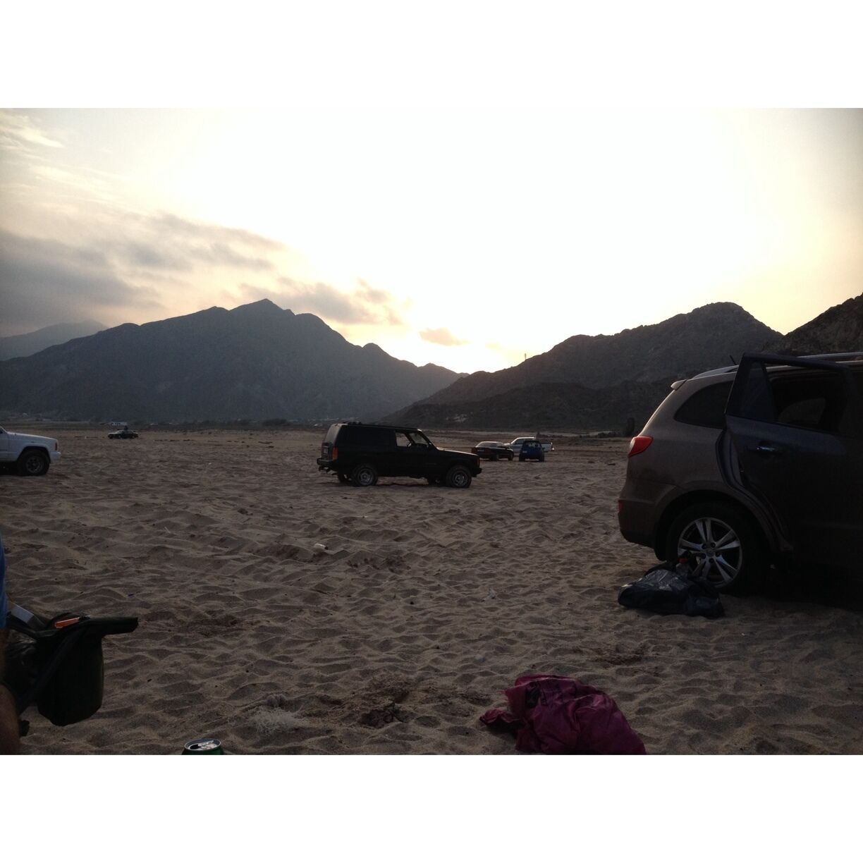 Public beach in Dibba, Fujairah at sunset. Quiet place at the Indian Ocean, where people usually camp overnight. The beach is "hidden" by some mountains and it's at aprox 200km from Dubai.