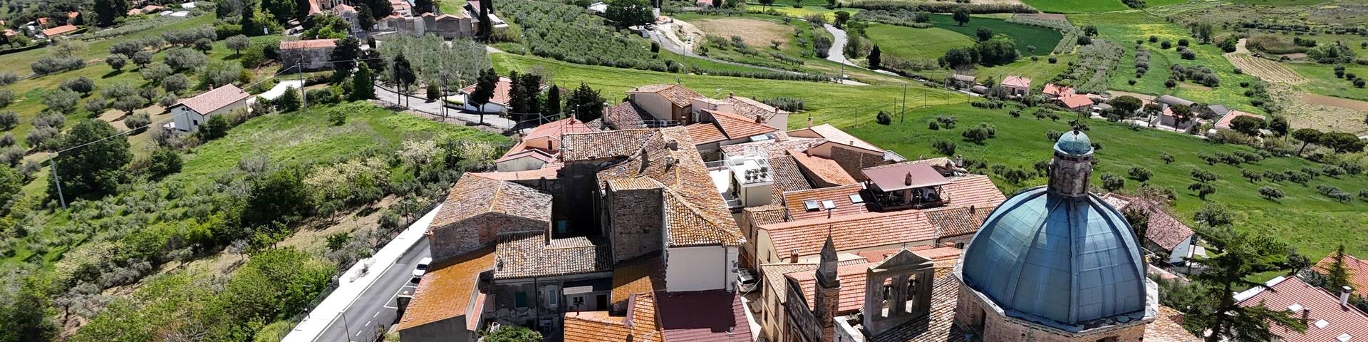 Aerial drone view of Montepagano hill with buildings in the province of Teramo in Italy and the Adriatic Sea.