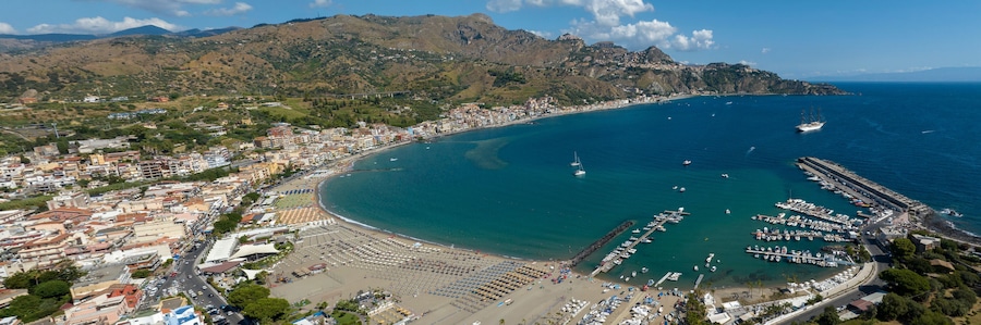 Aerial panoramic view of Giardini Naxos, a town in the province of Messina, Sicily, Italy. It is situated on the coast of the Ionian Sea. It is a popular tourist destination and a cruise ship stop.