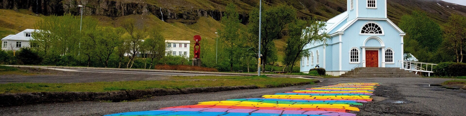 The Rainbow Road and The Blue Church are just two of the amazing sights you will find in eastern Iceland. A short distance from the Ring Road, Seydisfjordur is a great place to enjoy Icelandic food, nature, and festivals! #LifeAtExpedia #iceland #roadtrip