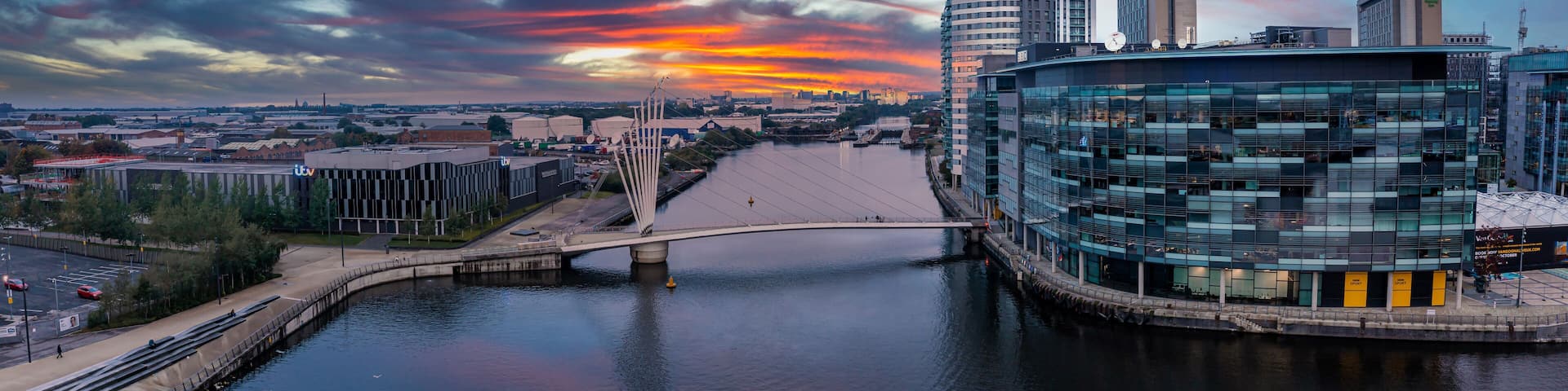 Aerial view of the Media City UK is on the banks of the Manchester Ship Canal in Salford and Trafford, Greater Manchester, England at dusk.