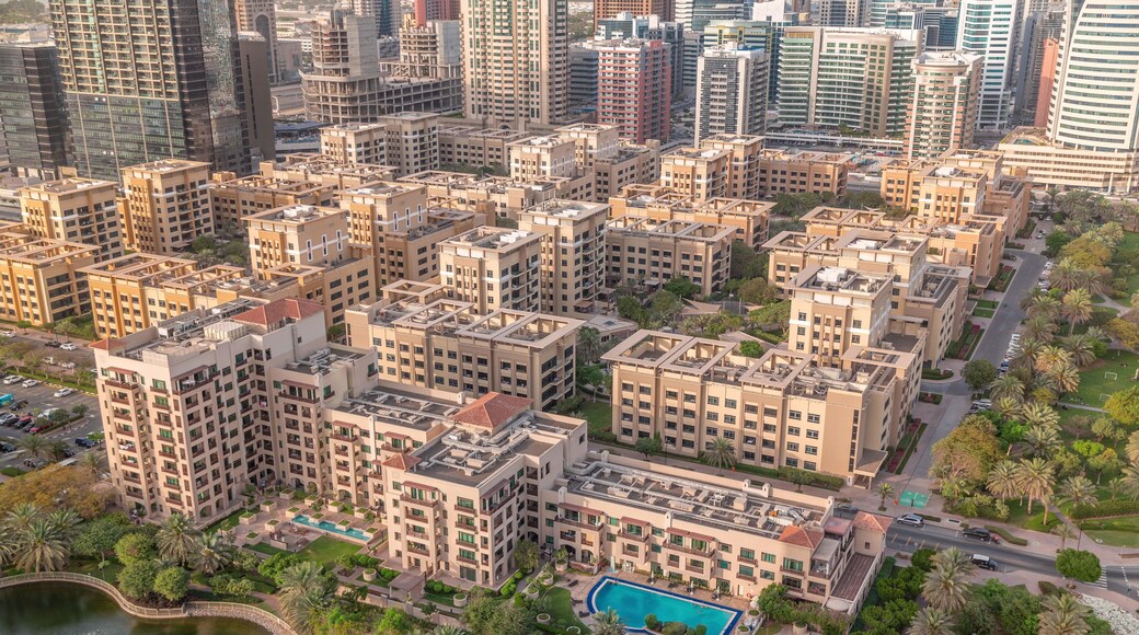 Low rise buildings in Greens district and skyscrapers in Barsha Heights district aerial timelapse. Dubai skyline