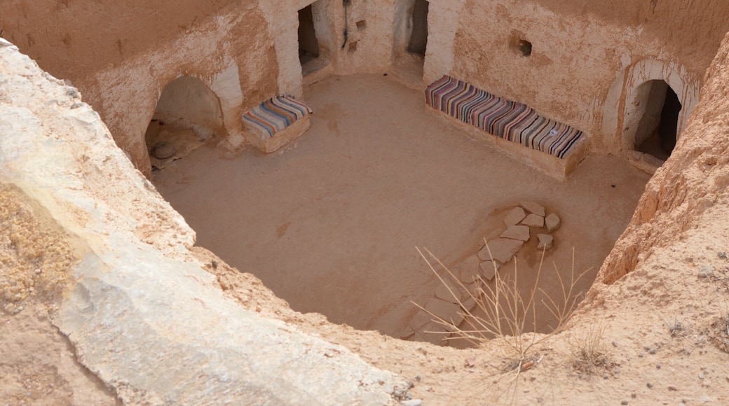 Underground Troglodyte house inner yard in Tunisia, Africa, rooftop Yellow sand, brown earthen and white plastered walls