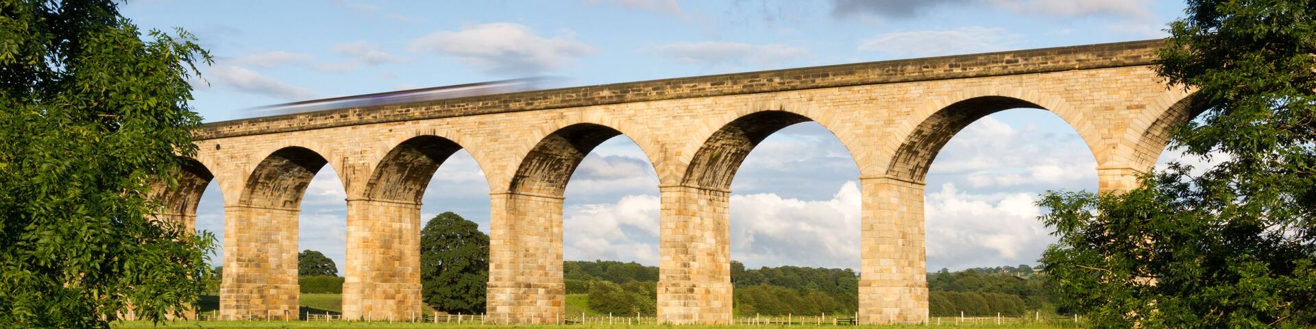 Railway viaduct, no train - the Arthington Viaduct and the mirror calm River Wharfe in West Yorkshire; Shutterstock ID 107768813