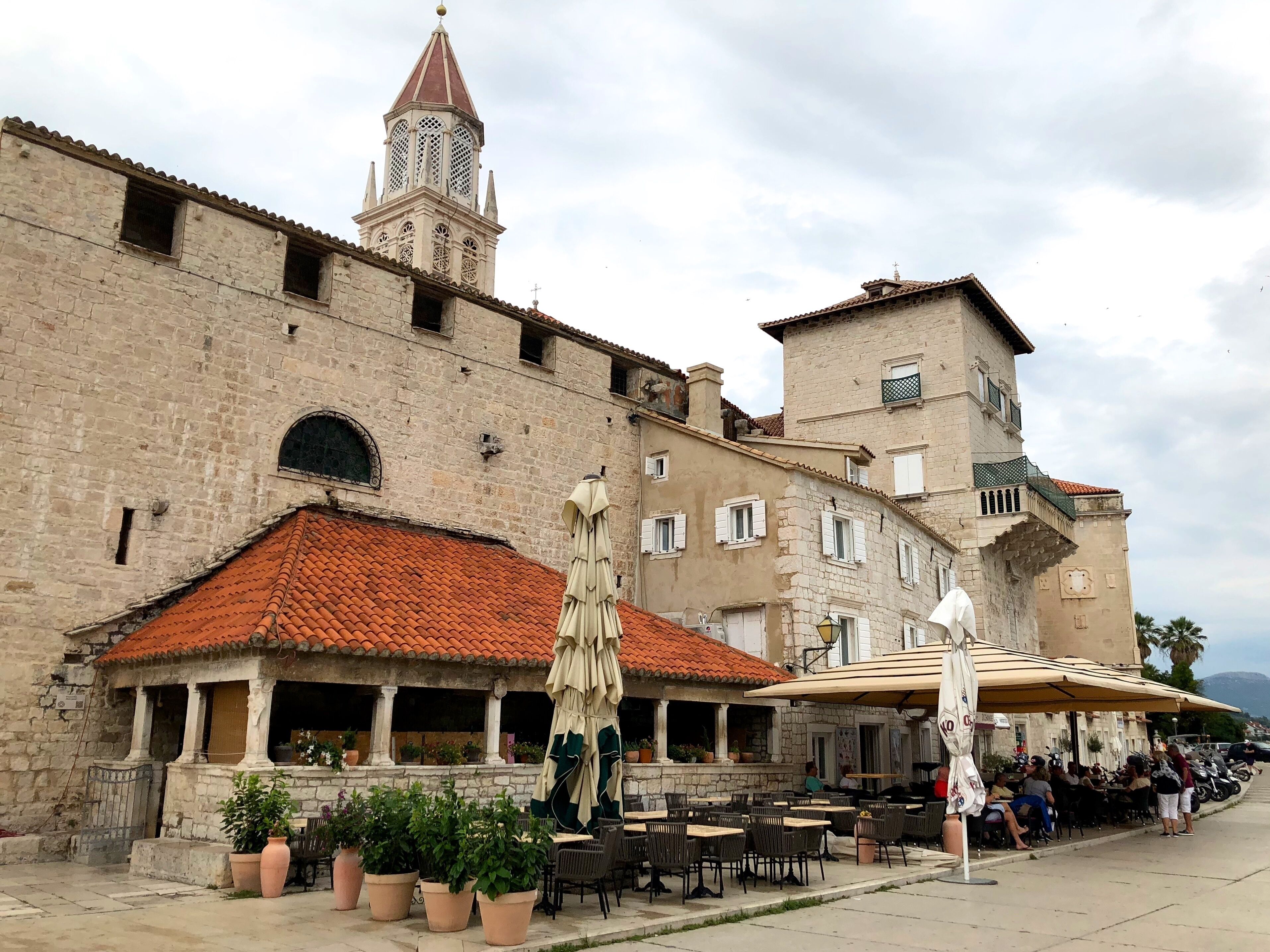 Trogir is a town on the central Adriatic coast of Croatia. Its preserved old town, known for its mix of Renaissance, baroque and Romanesque buildings, lies on a small island connected to the mainland and the island of Čiovo by bridges. The 13th-century Cathedral of St. Lawrence houses the Renaissance Chapel of St. John and offers sweeping views from its bell tower. Parts of the medieval city walls remain intact.
