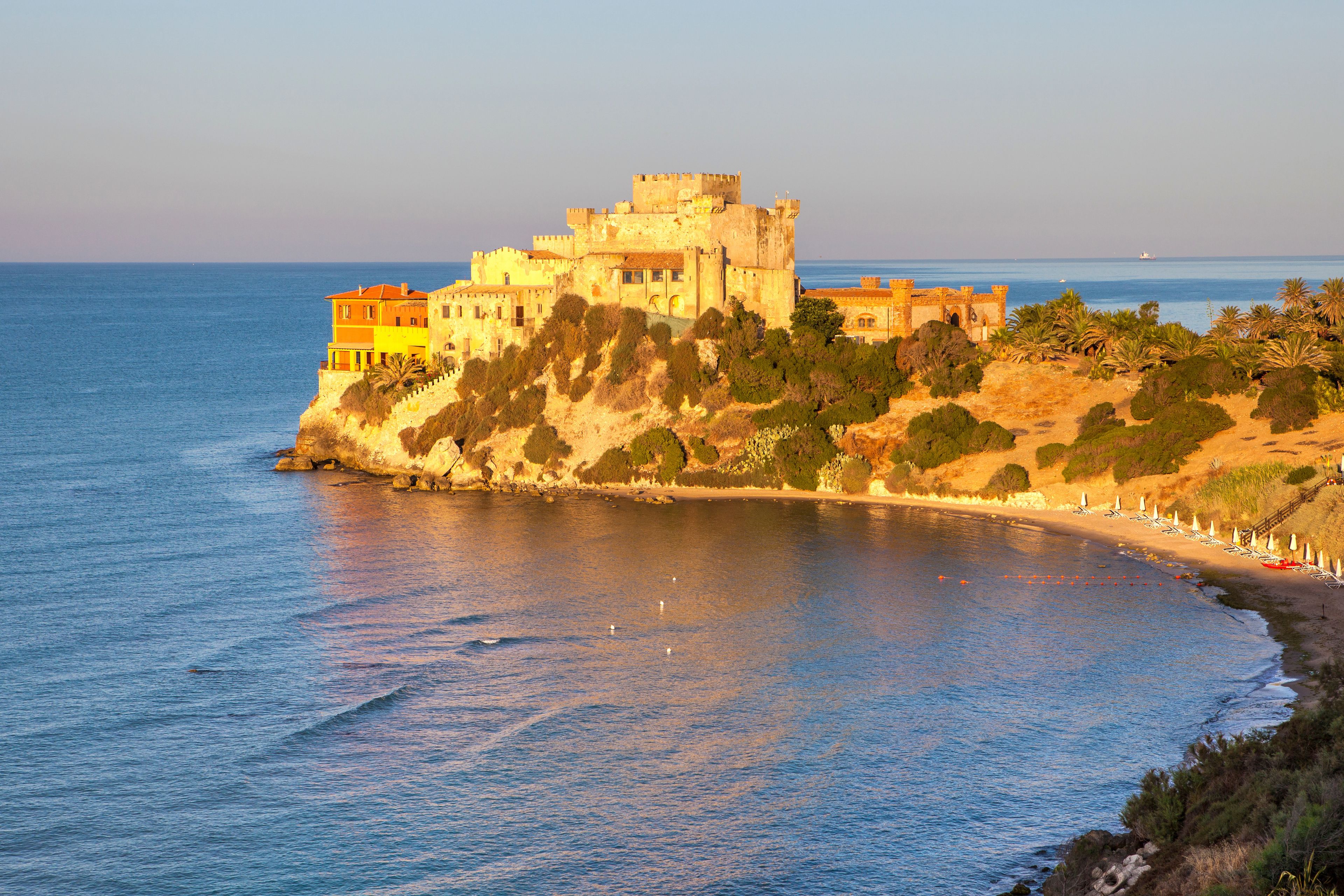 Sunrise on turquoise sea frames the medieval Falconara Castle, Butera, Province of Caltanissetta, Sicily, Mediterranean