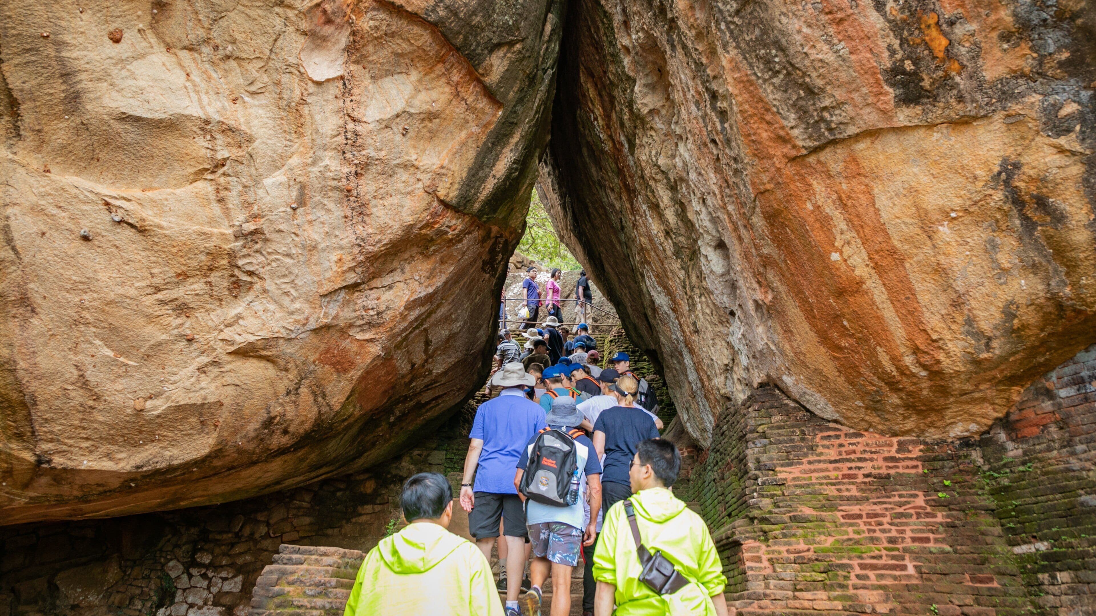 Sigiriya featuring hiking or walking and a gorge or canyon as well as a large group of people