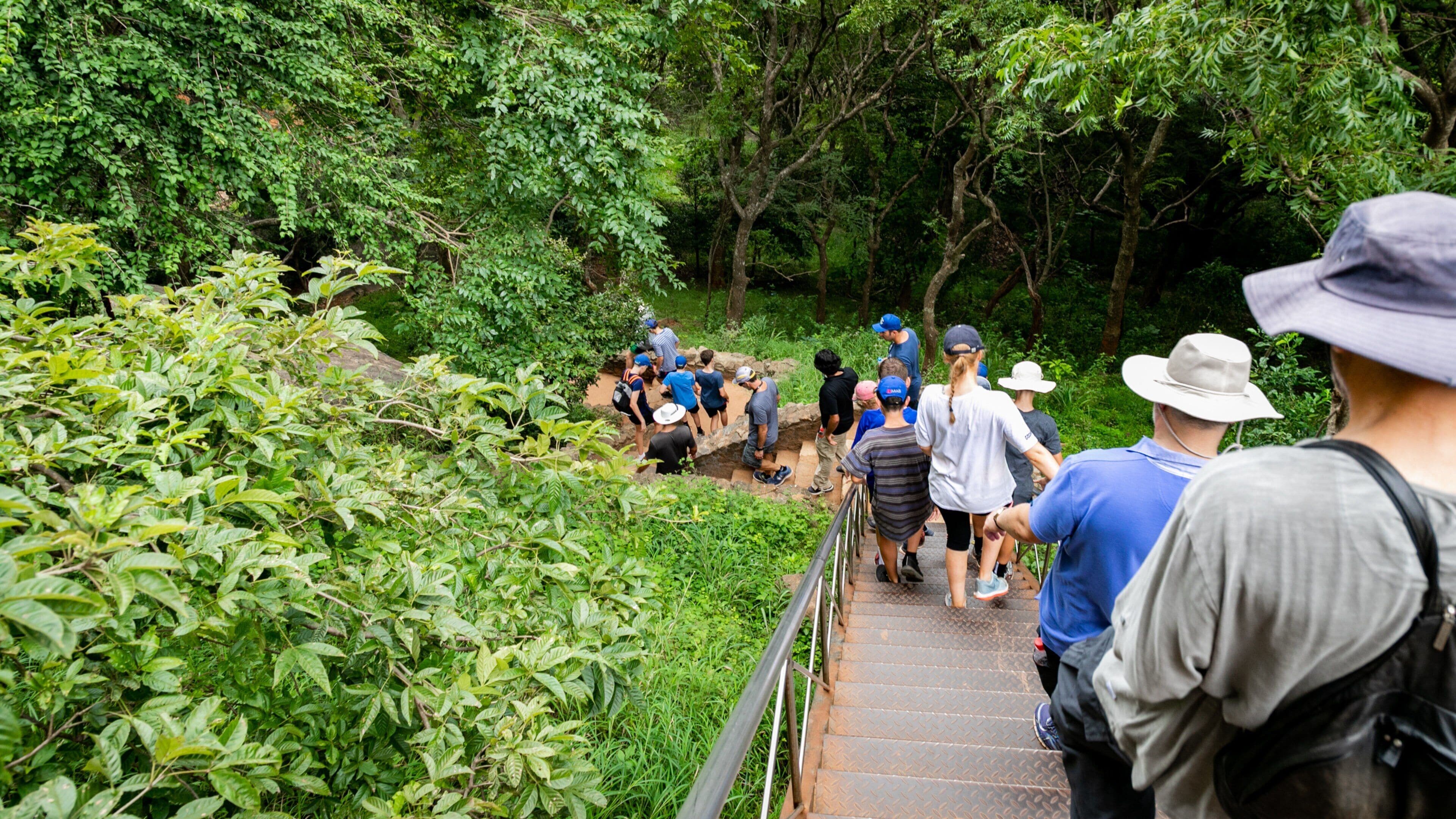 Sigiriya which includes hiking or walking as well as a large group of people