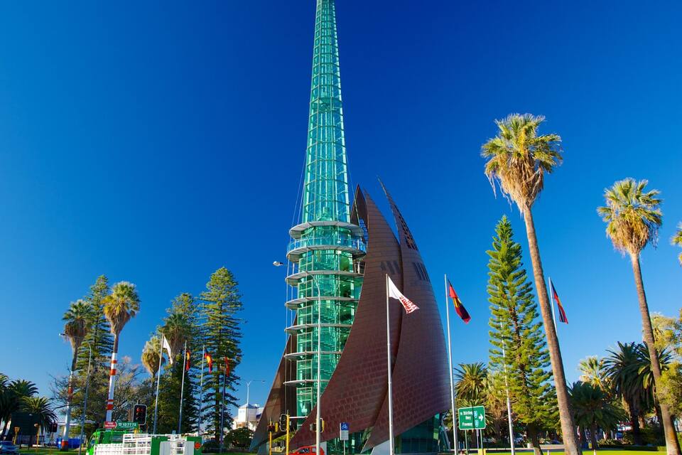 A tall, modern building with a glass facade and a unique, curved design.