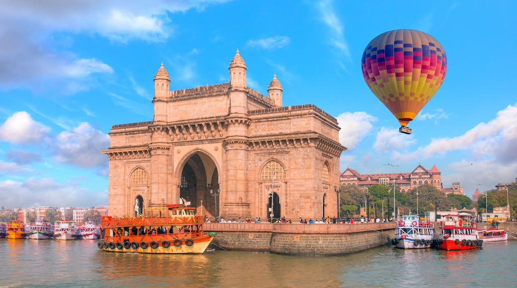 Hot air balloon flying over The Gateway of India and boats as seen from the Harbour - Mumbai, India