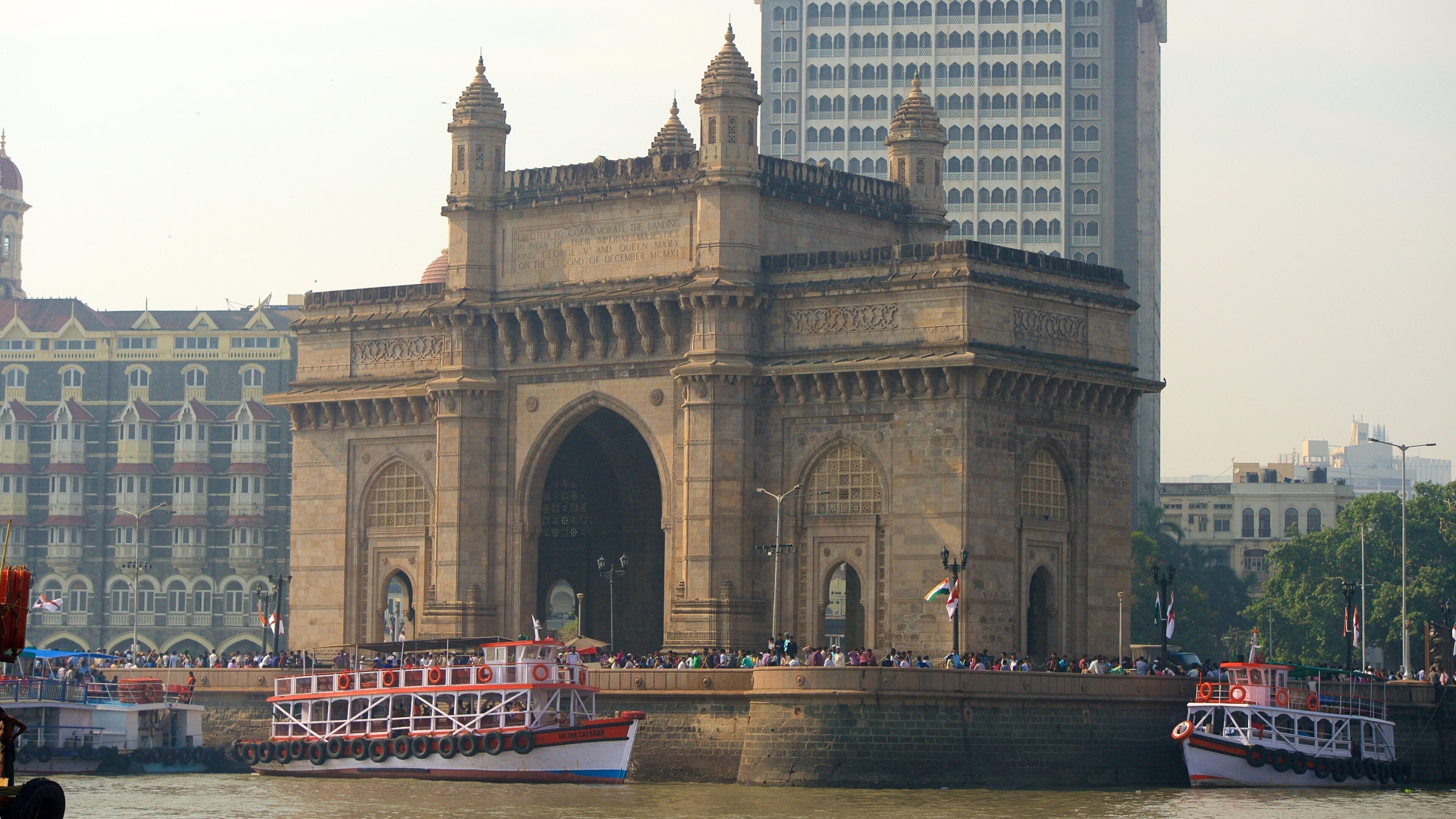Gateway of India which includes boating, a river or creek and heritage architecture