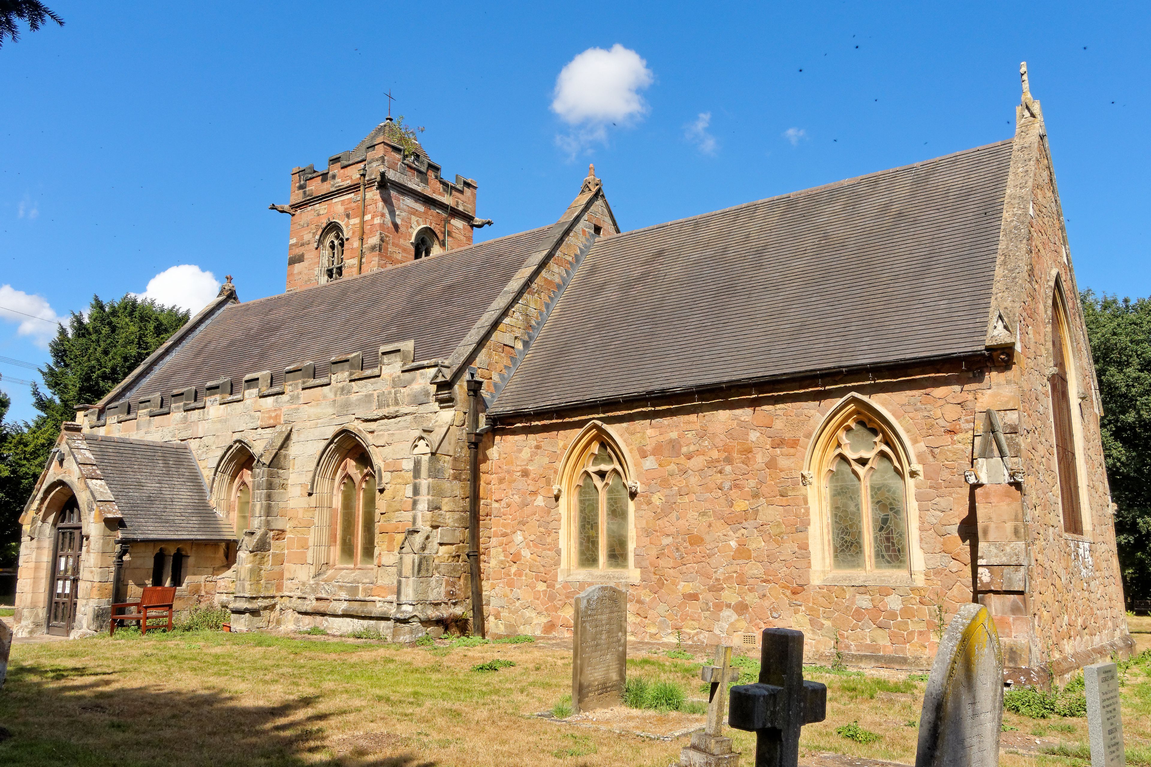 A historic church with a prominent tower and arched windows.