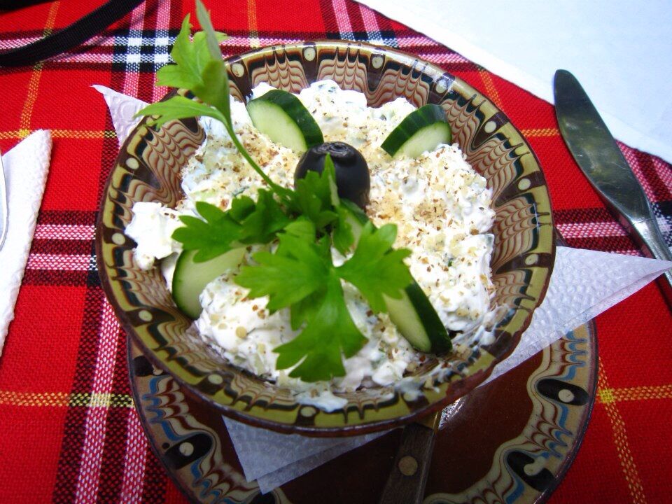 A traditional Bulgarian salad called "Snezhanka" made from plain yoghurt, cucumbers, ground walnuts, dill, olive and parsley! Literally translated this salad is called "Snow-white"