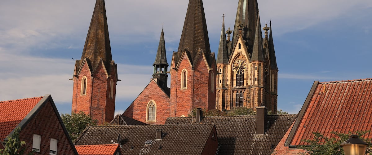 A church with multiple spires and a large clock tower.
