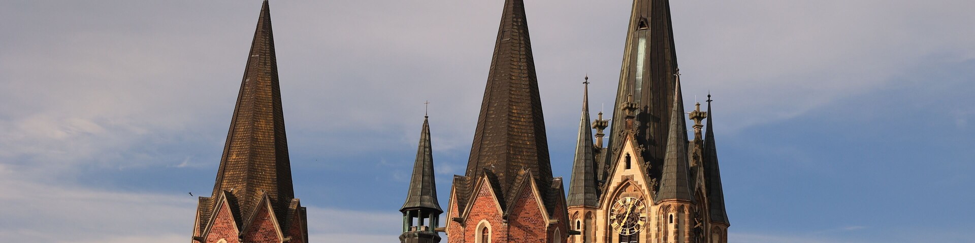 A church with multiple spires and a large clock tower.