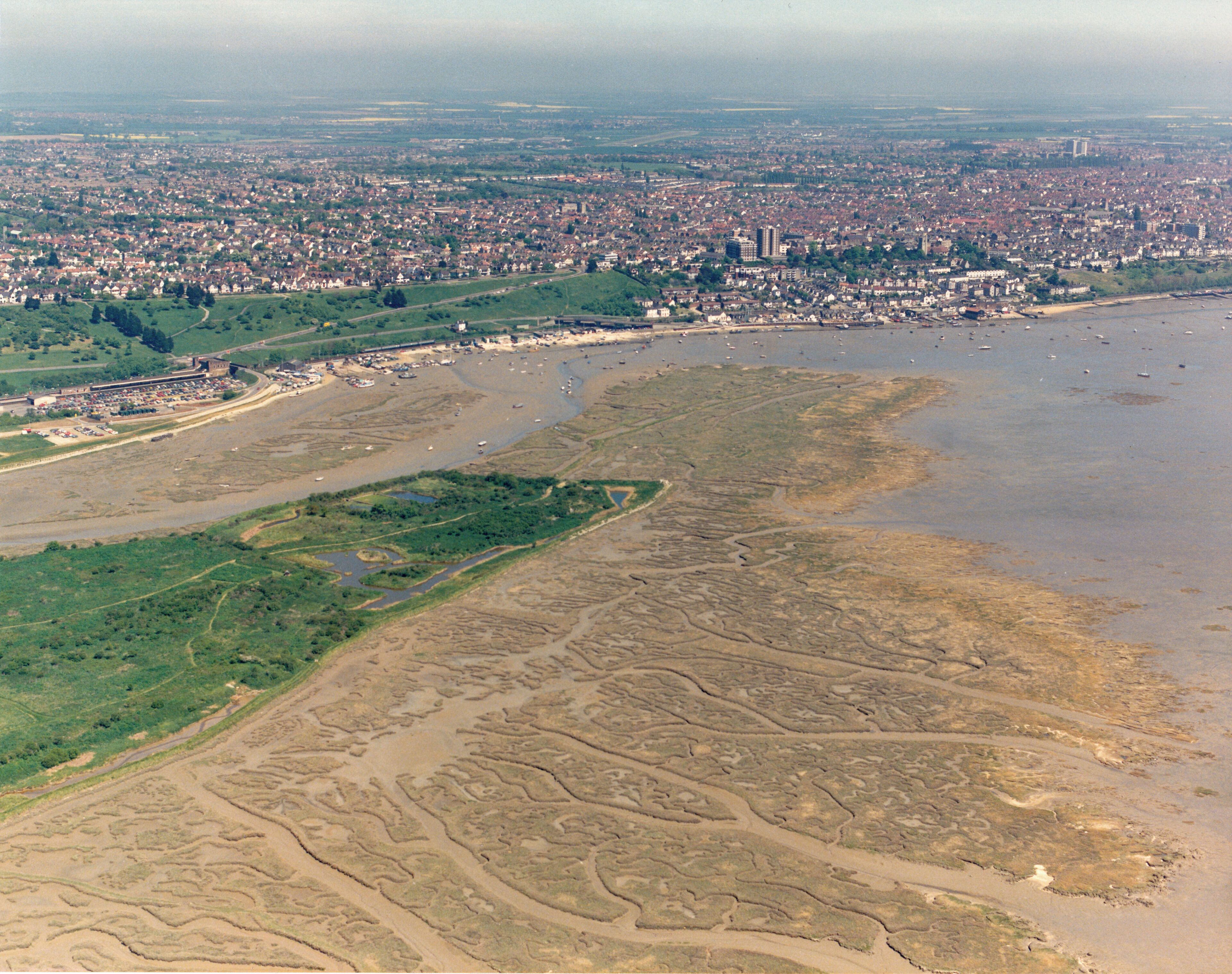 Aerial view of Two-Tree Island, eastern tip The eastern tip of Two-Tree Island lies within square TQ8385. It has a series of pools and dykes which attract birds, especially in the autumn. The extensive salt marsh to the right is rather bleached in August, but will form a roosting area for waders in winter at high tide. The buildings at the centre-right are those around Leigh station. Behind then are the green Belton Hills. Further along the coast above right of centre is Old Leigh.