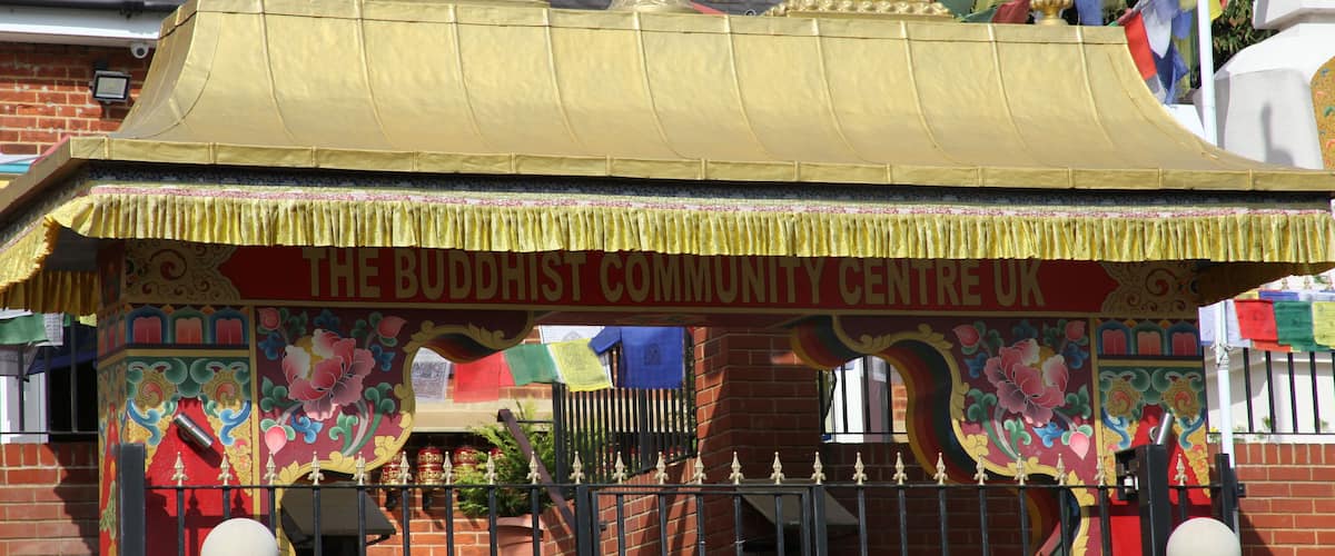 A Buddhist community center with a golden roof and colorful decorations.
