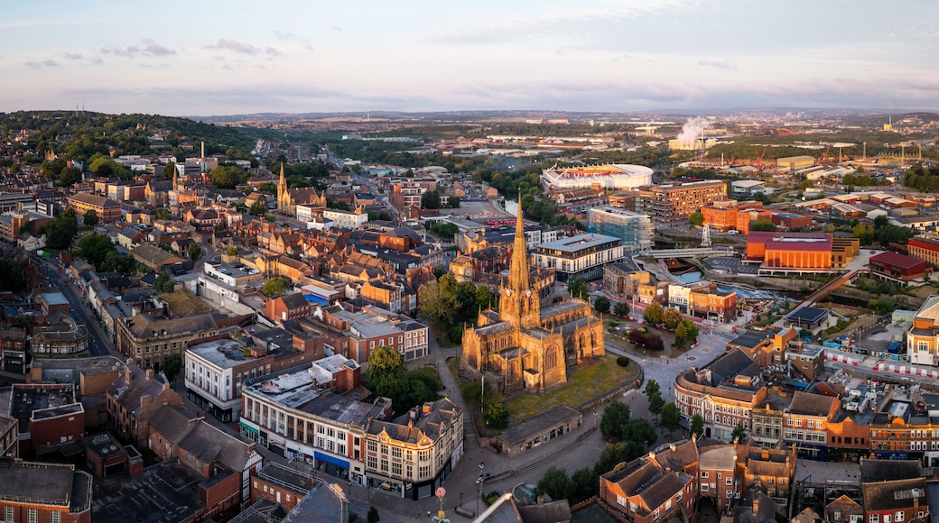A cityscape with a prominent cathedral, a stadium, and a mix of historical and modern buildings.