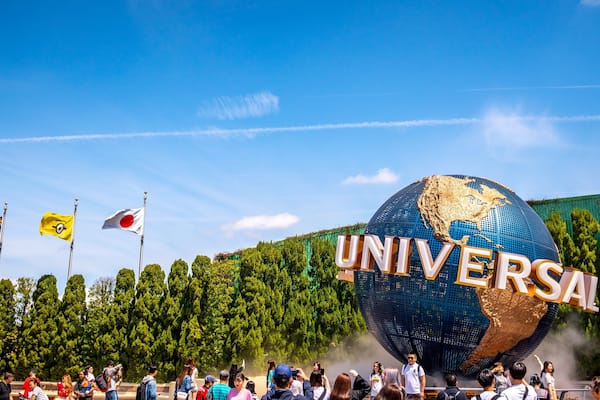 Universal Studios Japanâą featuring rides and signage as well as a large group of people