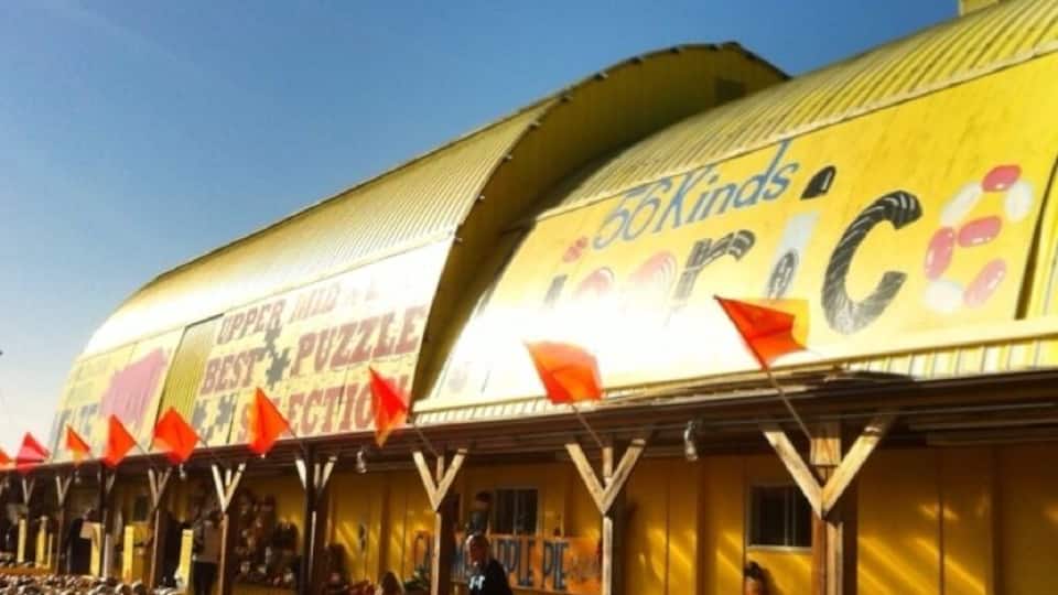 A building with a yellow facade and the words "56Kinds of Ice Cream" on it.