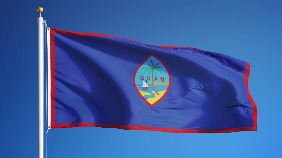 Guam flag waving against clean blue sky, close up, isolated with clipping path mask alpha channel transparency