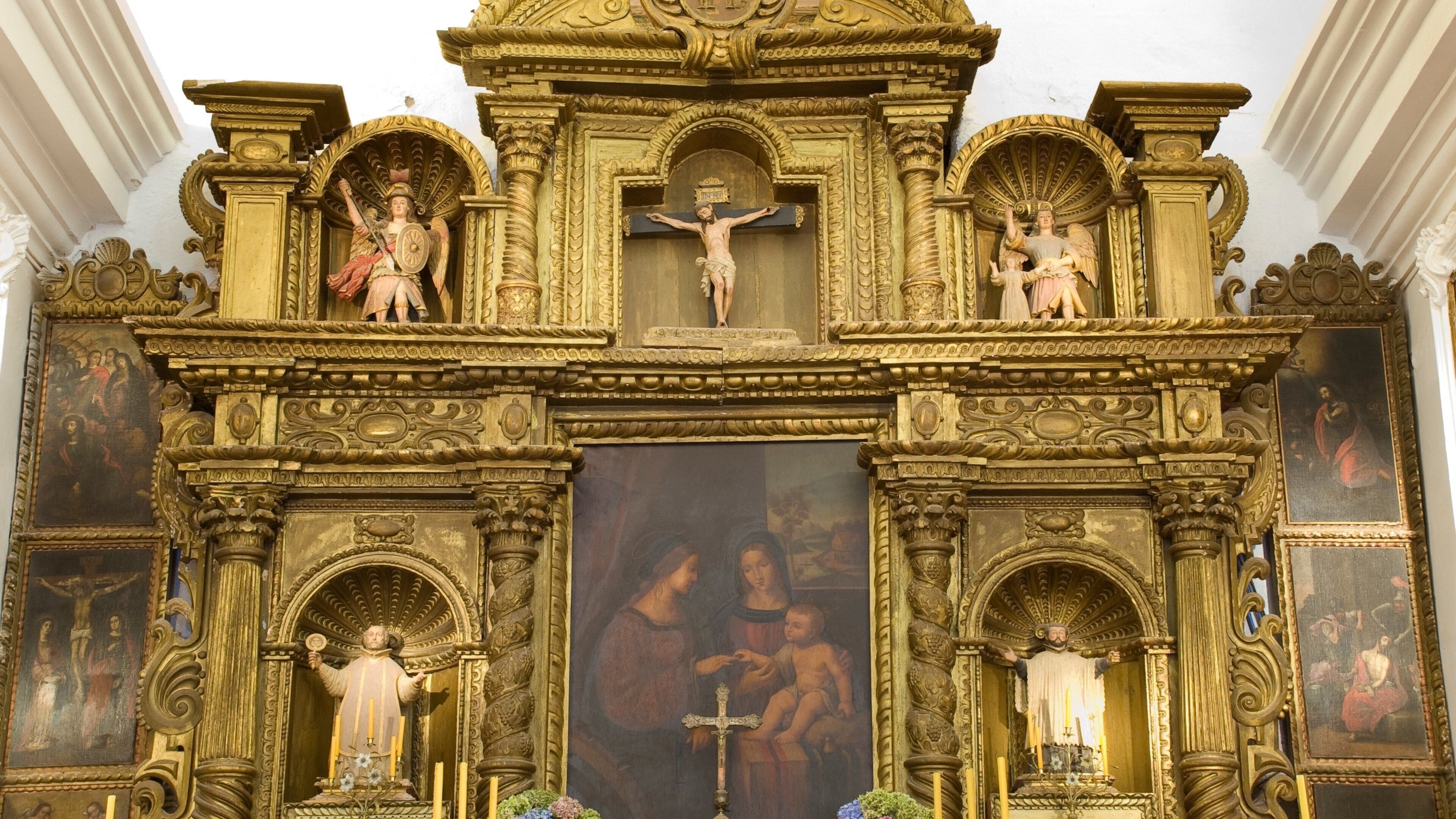 An ornate religious altar with statues and paintings.