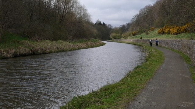 Walkers on Union Canal Two people take the canal path towards the Edinburgh International Climbing Arena. The path is heavily used by walkers, cyclists and anglers.