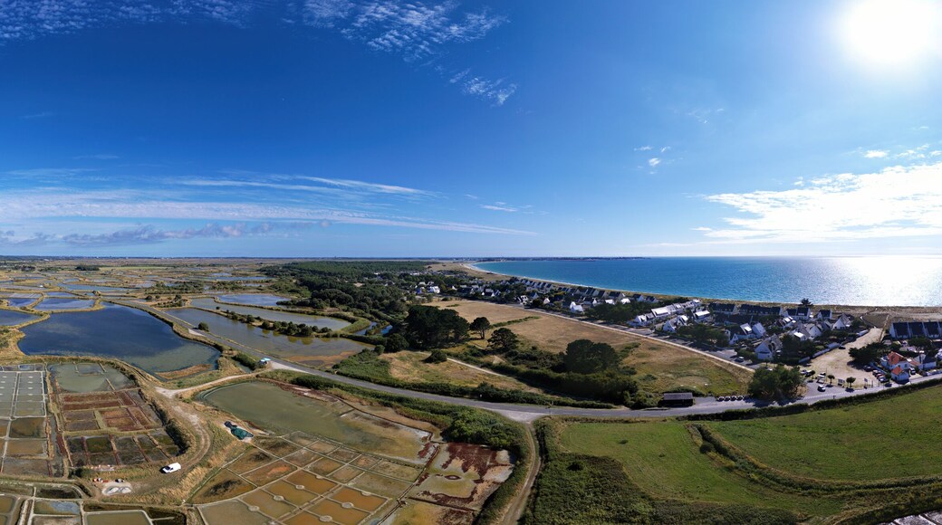Panorama with sea salt marshes of Guerande, La Turballe with Pen Bron and Le Croisic with sea in the peninsula of Guerande, Brittany, France, drone photo