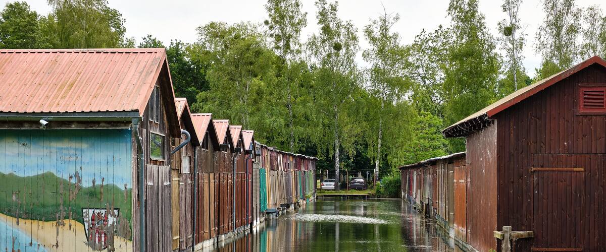 Colorful old boathouses along the waterfront at Tollense See Neubrandenburg