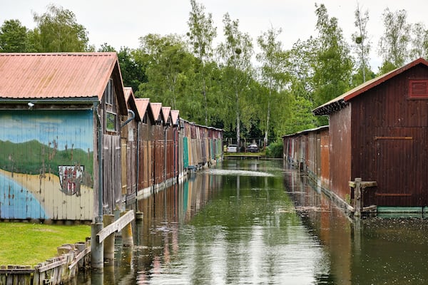 Colorful old boathouses along the waterfront at Tollense See Neubrandenburg