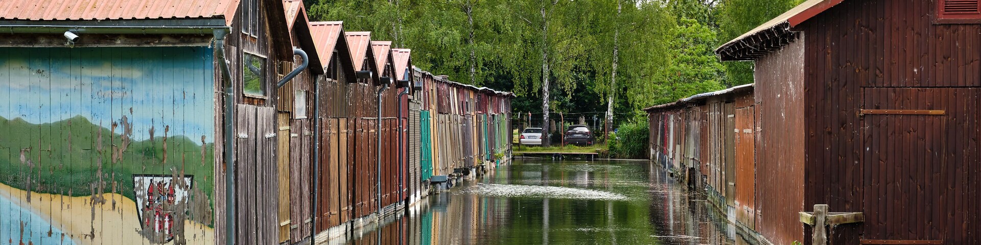 Colorful old boathouses along the waterfront at Tollense See Neubrandenburg
