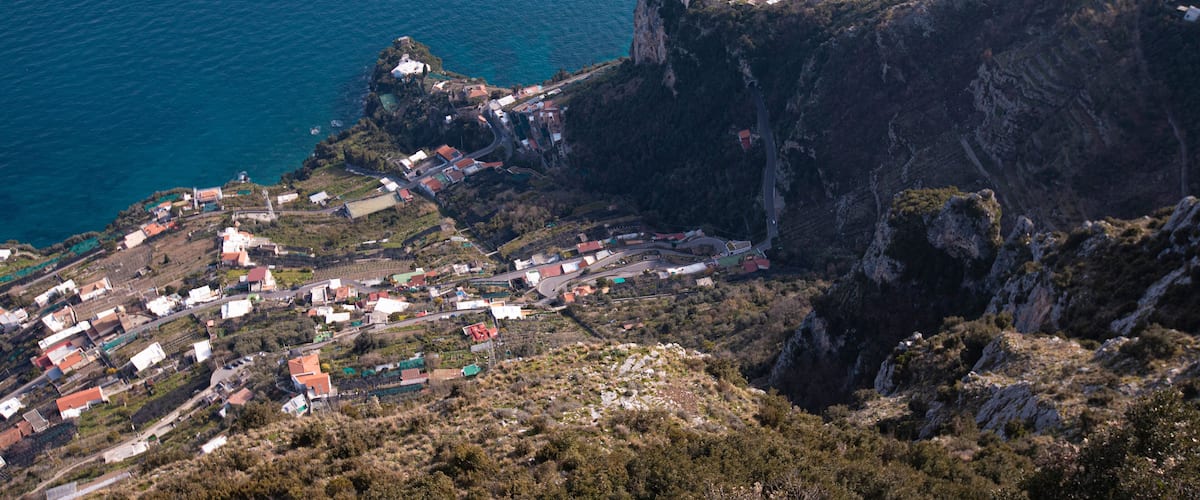 A coastal village perched on a cliff with a sea view.