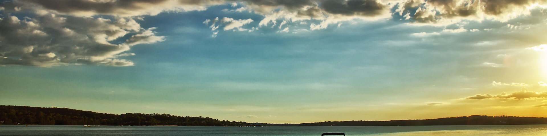 Motor boats moored on a jetty on Lake Macquarie, Australia at sunset
