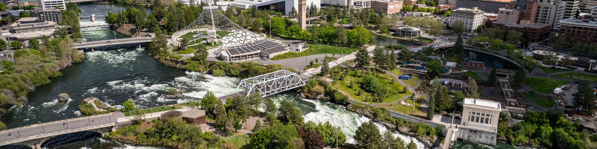 Wide angle view of downtown Spokane, WA cityscape with view of pavilion and Spokane River during the day, United States