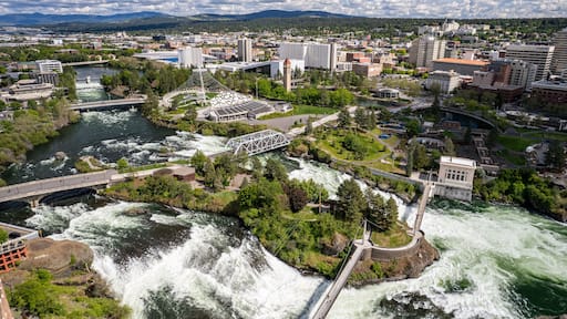 Wide angle view of downtown Spokane, WA cityscape with view of pavilion and Spokane River during the day, United States