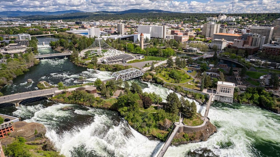 A cityscape with a river, bridges, and a dam.