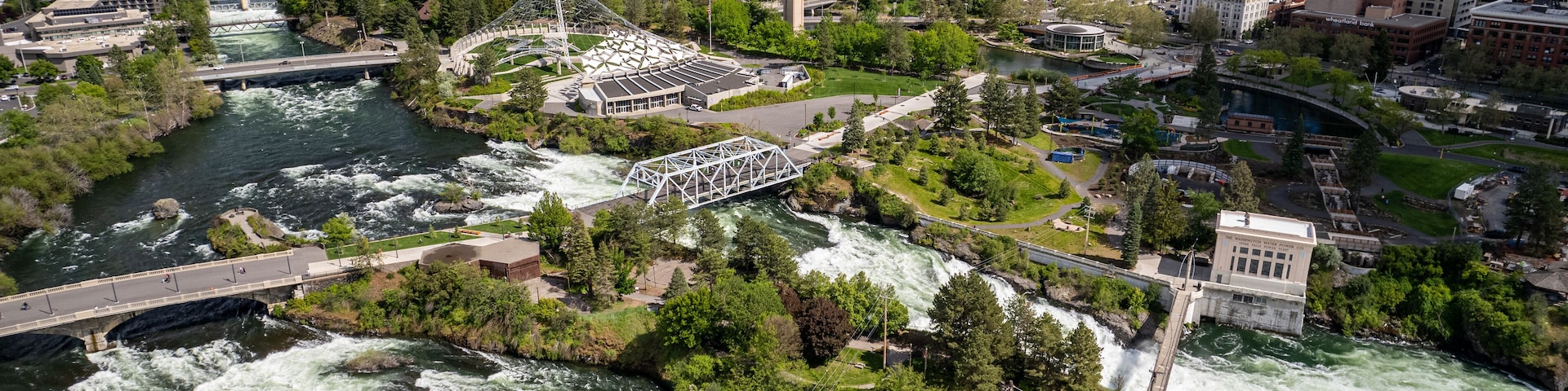 Wide angle view of downtown Spokane, WA cityscape with view of pavilion and Spokane River during the day, United States
