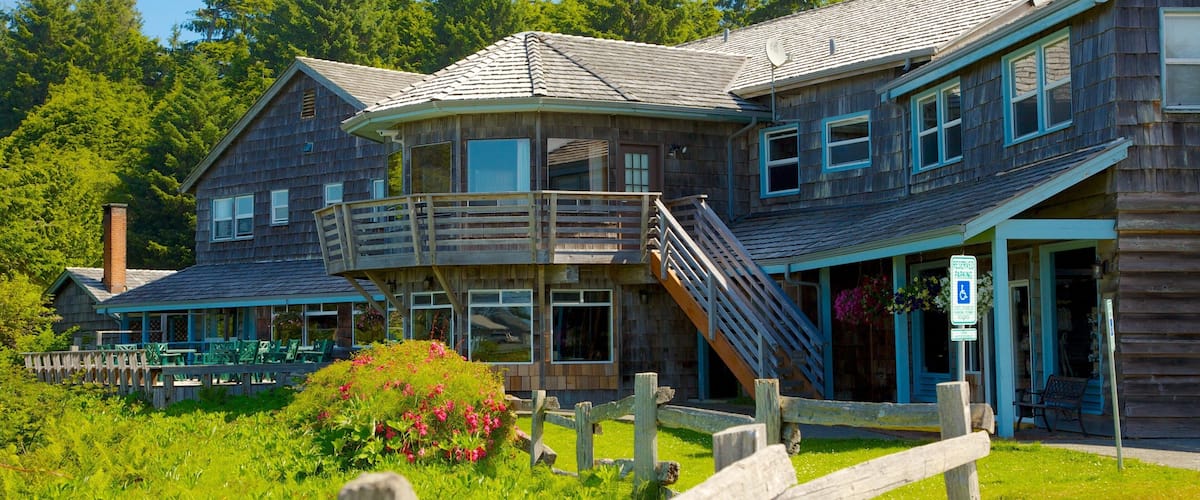 A wooden building with a balcony and a wheelchair-accessible entrance.
