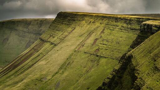 The Brecon Beacons (Welsh: Bannau Brycheiniog) is a mountain range in South Wales. In a narrow sense, the name refers to the range of Old Red Sandstone peaks which lie to the south of Brecon. Sometimes referred to as "the central Beacons" they include South Wales' highest mountain, Pen y Fan. The range forms the central section of the Brecon Beacons National Park