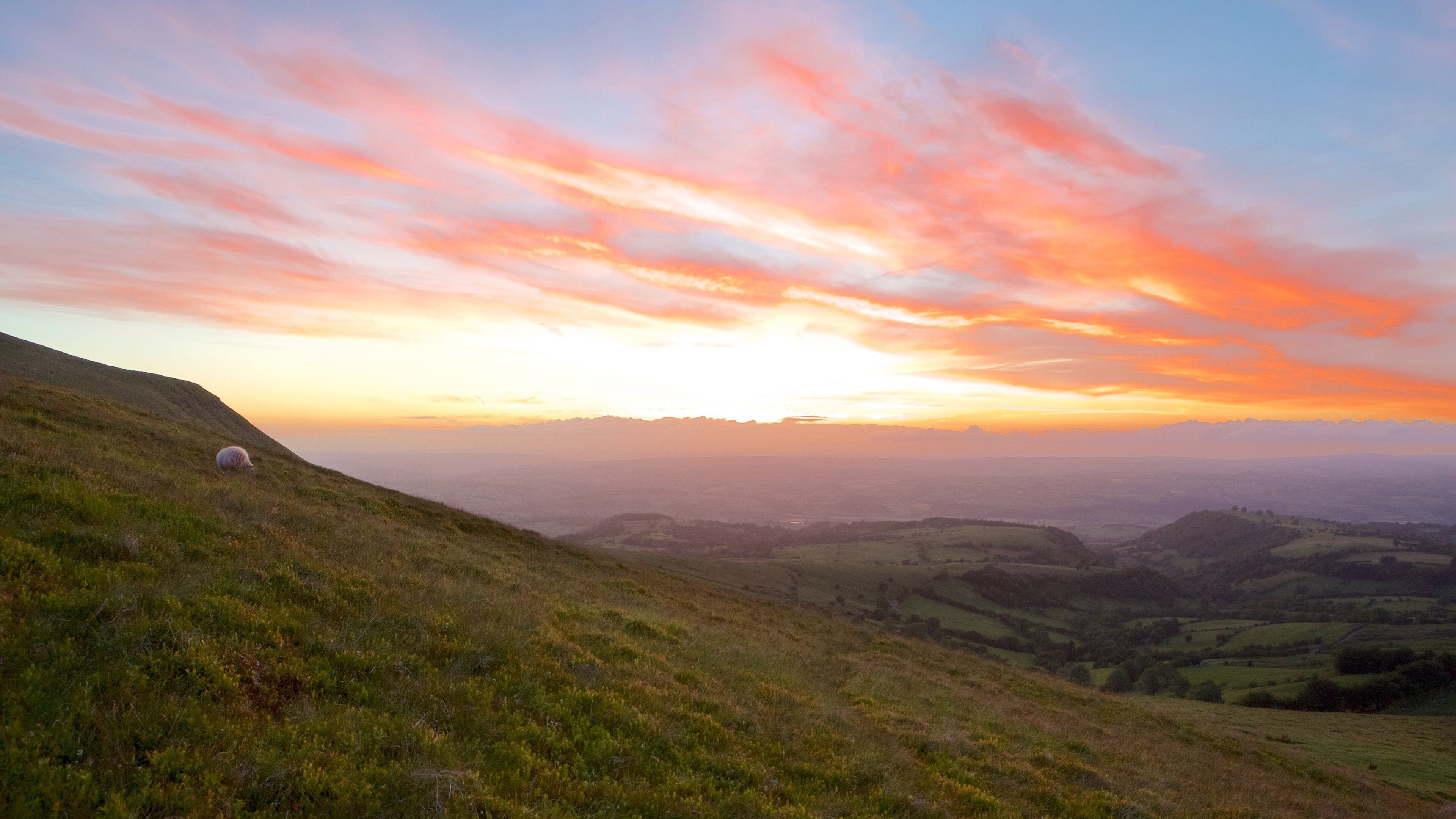 Brecon Beacons National Park showing mountains, a sunset and farmland