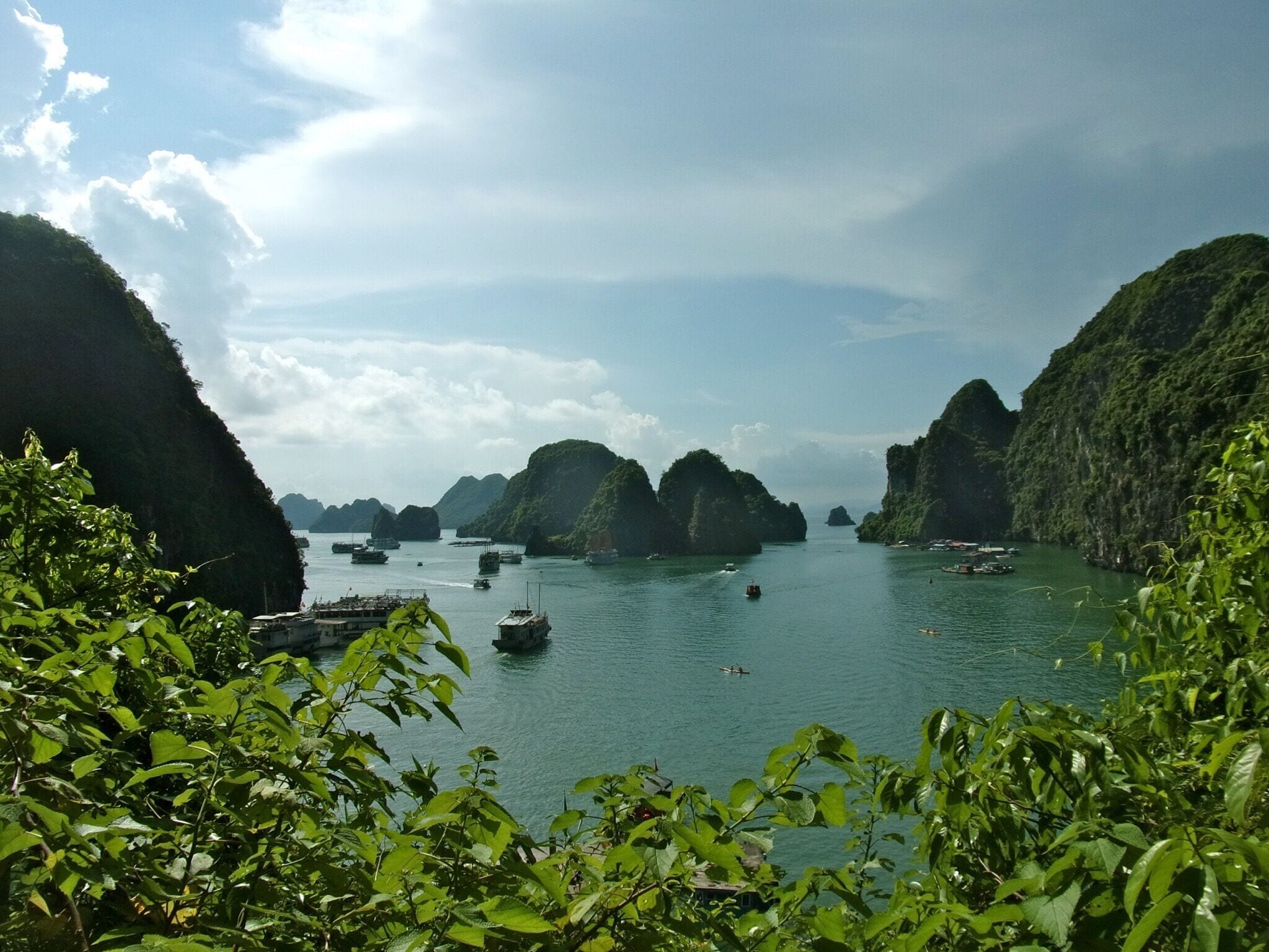 A coastal landscape with green hills and a calm sea.