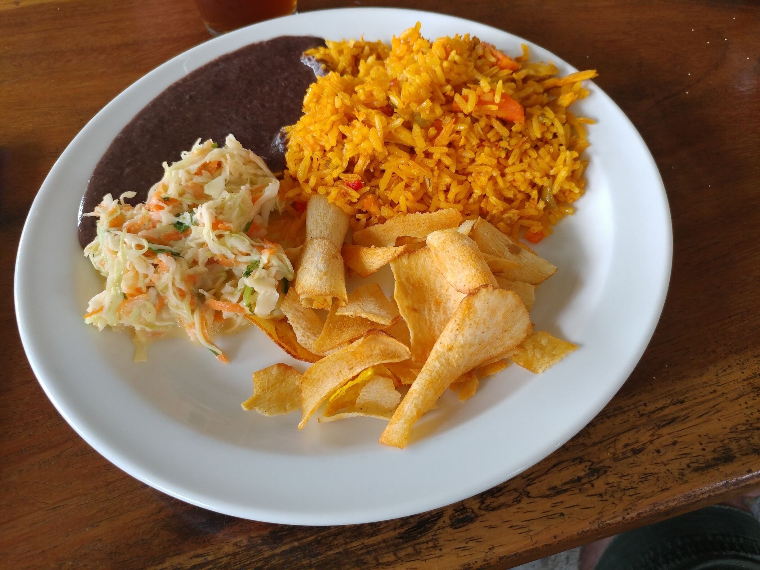 A lunch of refried beans, cole slaw, yucca chips and rice with chicken served to us at a local restaurant in Los Chiles as part of the Caño Negro/Río Frío boat tour.

#FoodieFinds