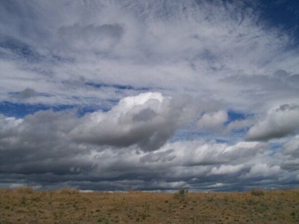 Earth meets sky. Took this while driving. Talk about a lucky shot!