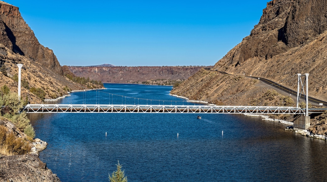 The one-lane bridge spans the Deschutes River flowing between steep basalt cliffs at Cove Palisades State Park, Oregon, USA