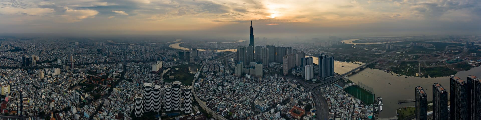 A cityscape with a prominent skyscraper, a river, and a bridge.