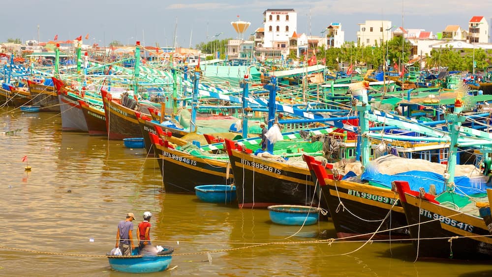 A bustling harbor filled with colorful fishing boats docked in rows.