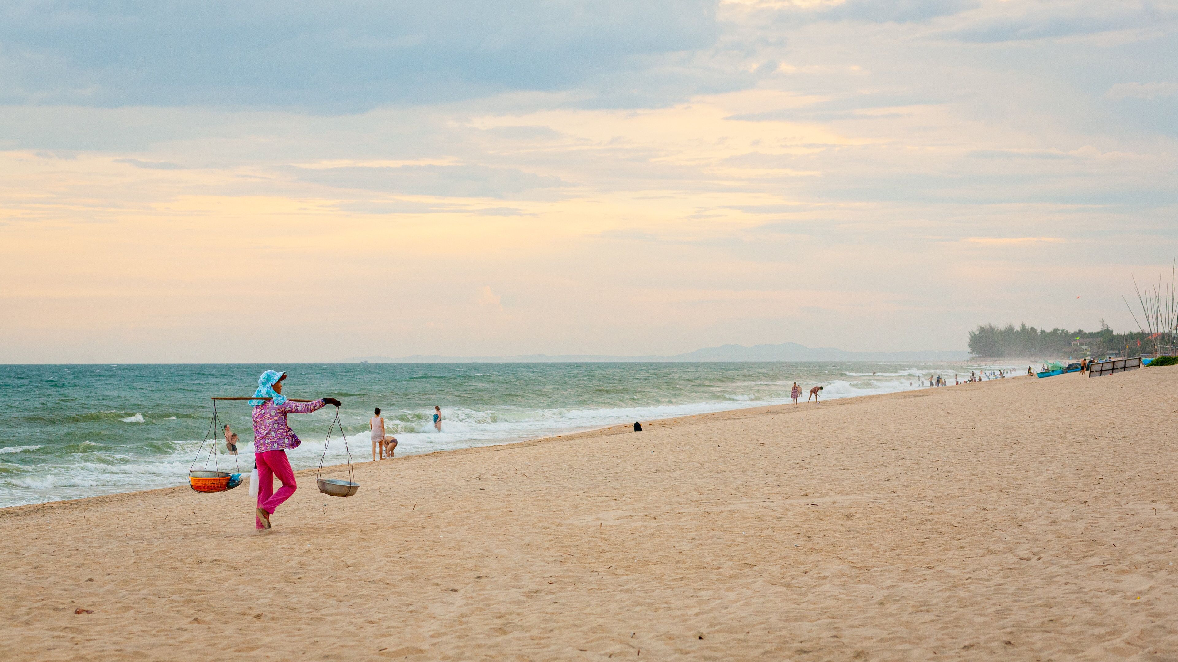 Mui Ne Beach showing a sandy beach and general coastal views as well as an individual femail