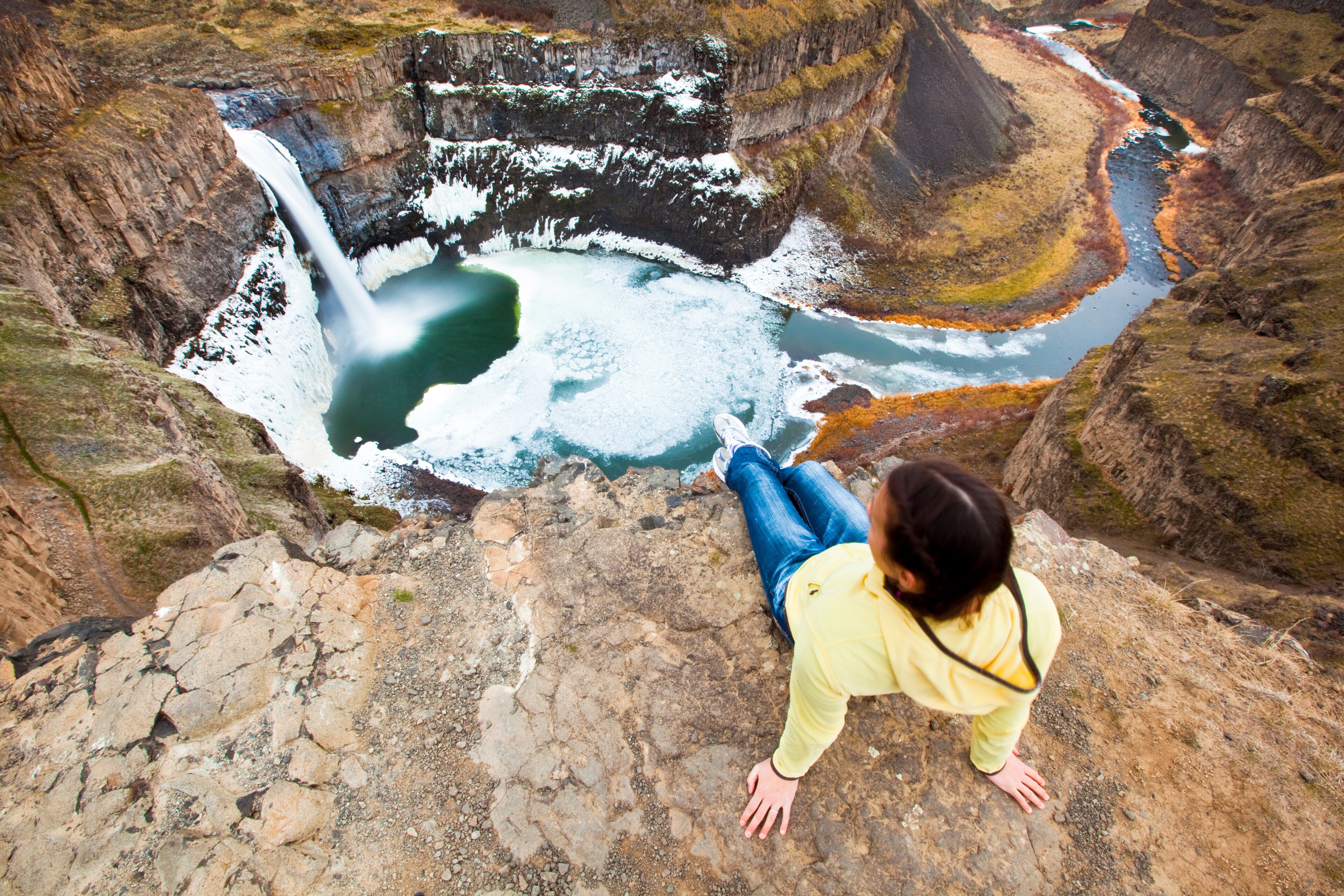 A woman takes in the view of the beautiful 180-foot Palouse Falls during a nice winter day in southeastern Washington.      